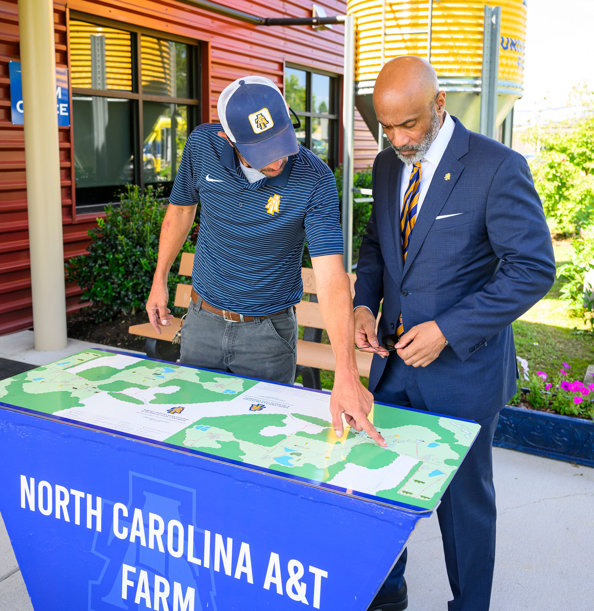 Chancellor Martin and a University Farm employee examine a map of the farm.