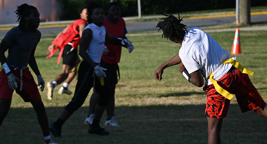 Flag football player throwing football