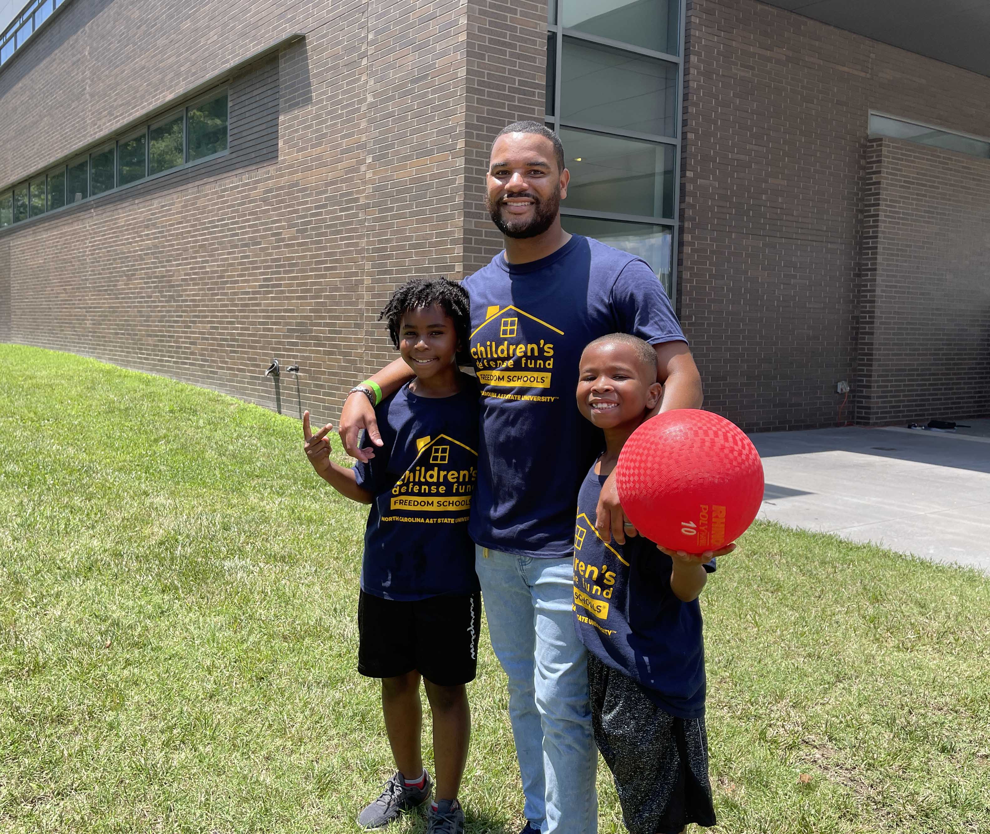 Professor with two young elementary students