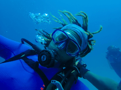 A closeup of D’Karia Bascom underwater in the ocean